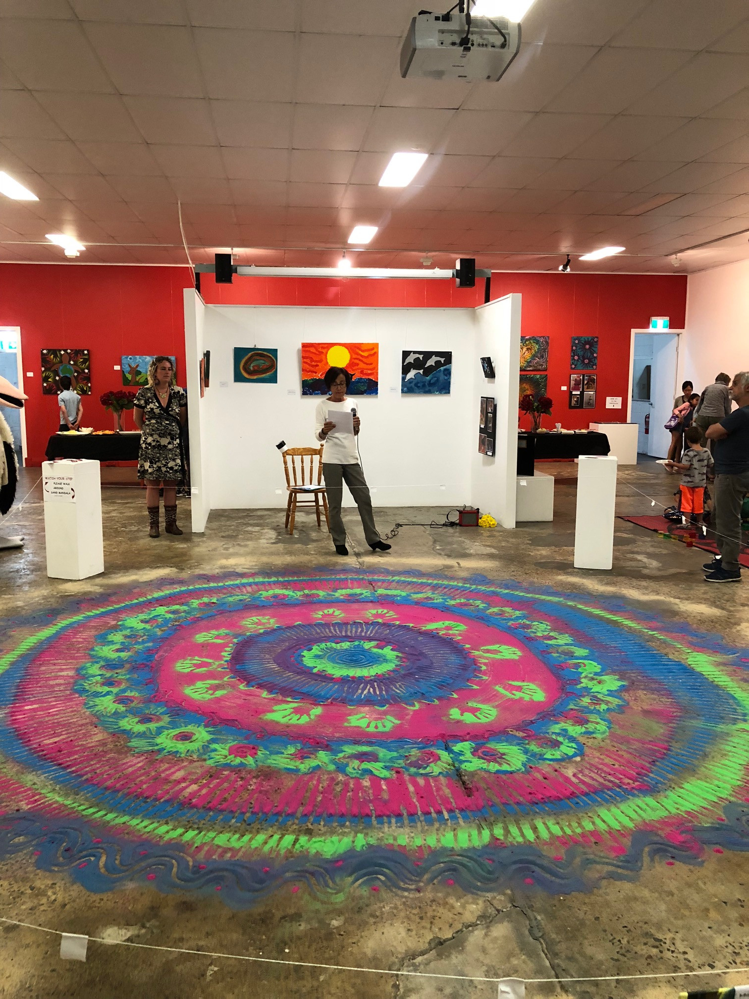Colourful mandala artwork on a gallery floor